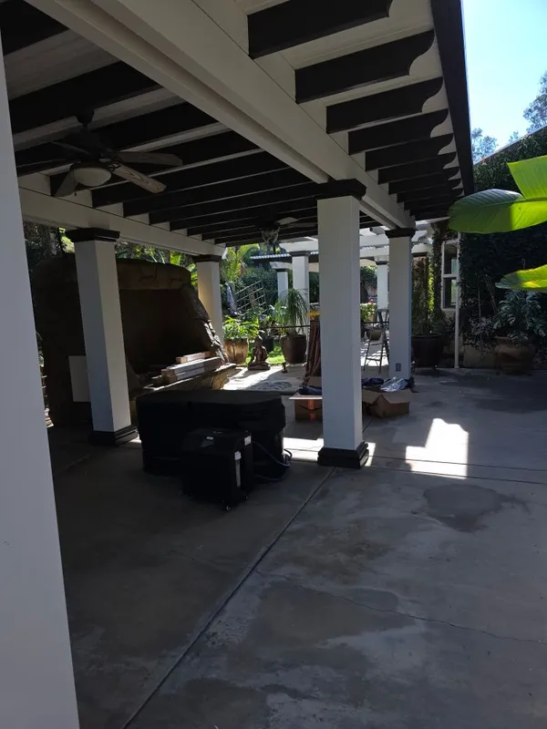 Balcony railing and trim painted in two colors by Ortiz Quality Painting Services