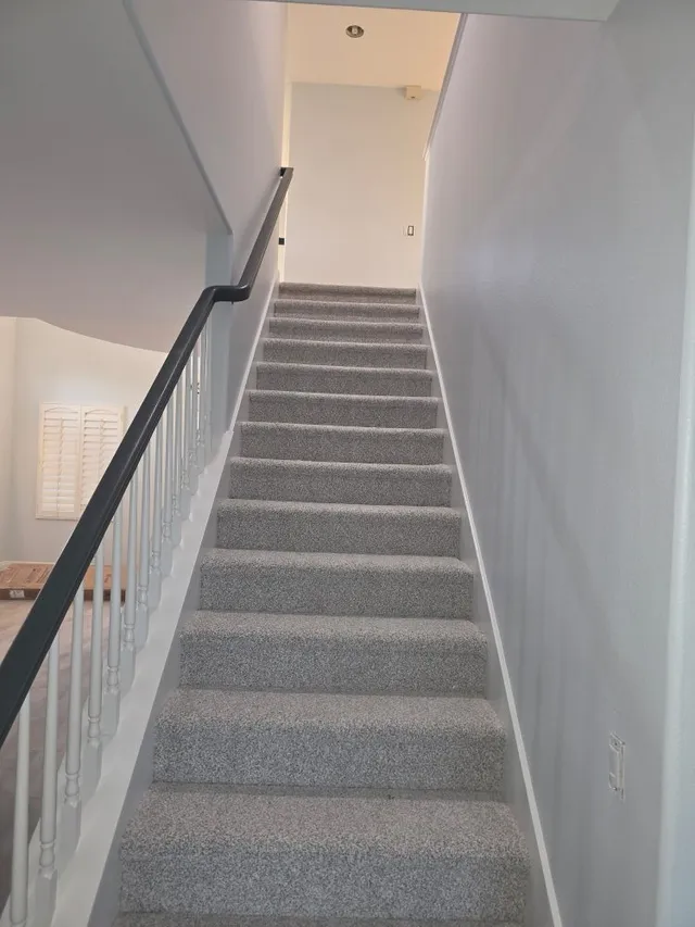 Interior painting of stairway walls and railings by Ortiz Quality Painting